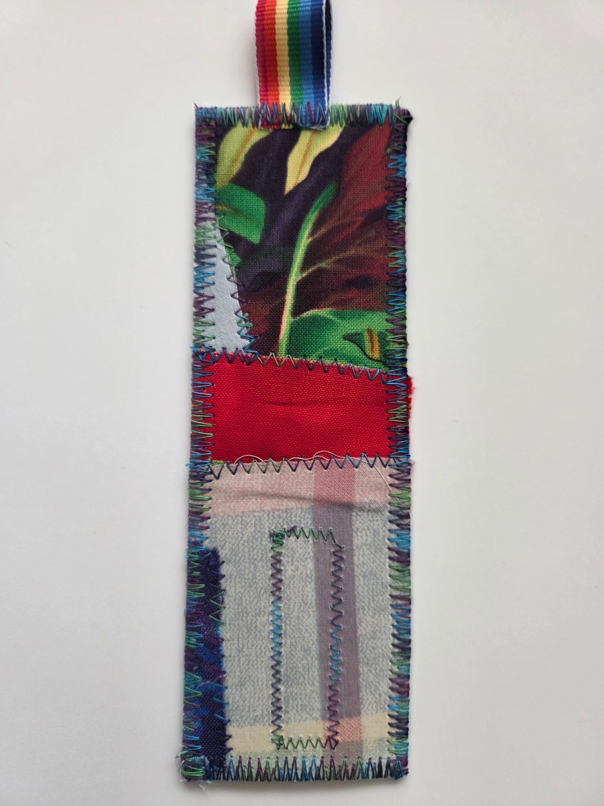 Colorful woven bookmark with a multicolored ribbon on a white background